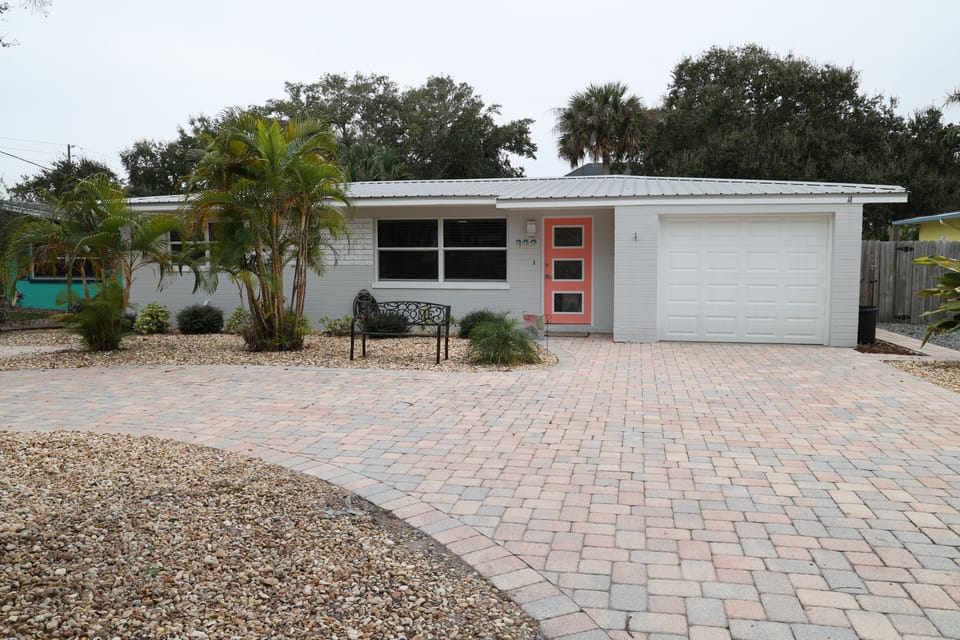 Newly painted and new roof with spectacular coral painted front door. Bench also