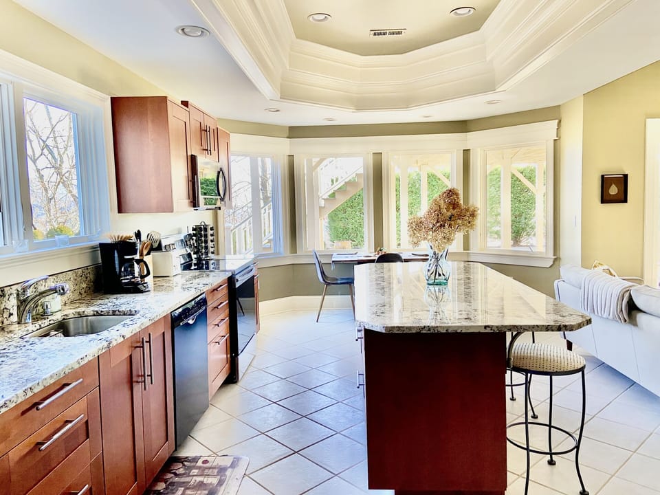 Full size kitchen with all appliances, granite countertops, spice rack, coffee..
