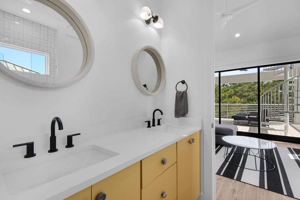 Bunk Bathroom features double vanities and tub.