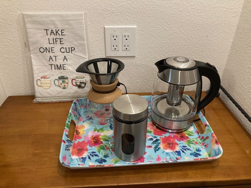 Pour over coffee maker, electric kettle, coffee, decaf, tea, cream & sweetner.