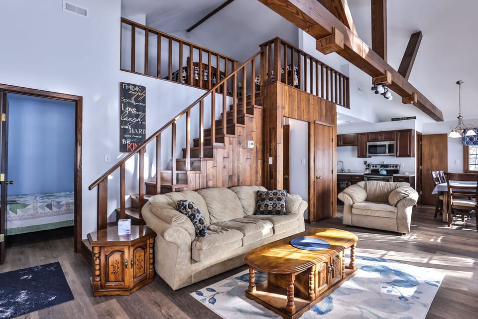 Beautiful wooden stairs leading a spacious loft area