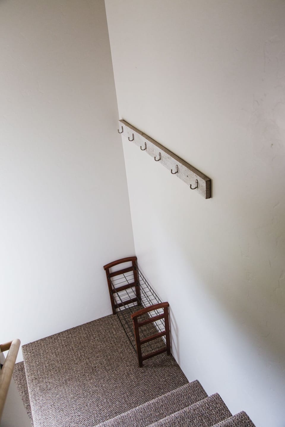 Coat/shoe station in entry/stairwell.