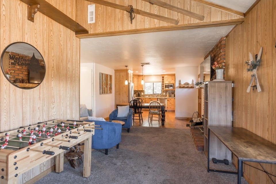 Foosball table by the entry w/ open flow into the living & dining space.