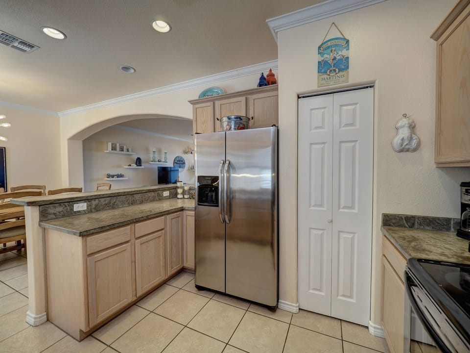 Kitchen with stainless steel refrigerator, ice and water dispenser. 
