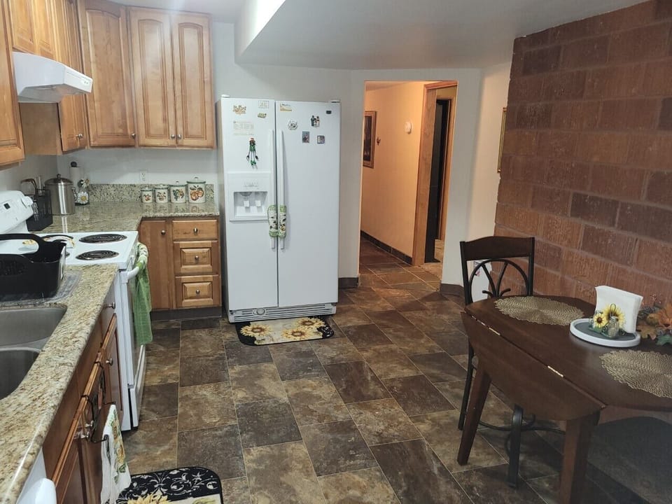 Kitchen, refrigerator, dishwasher,stove, microwave, Pots, pans, dishes and table