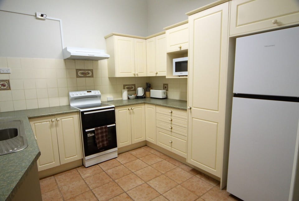 Equipped with quality appliances, cookware, cutlery, and dining essentials for in-house meal preparation.