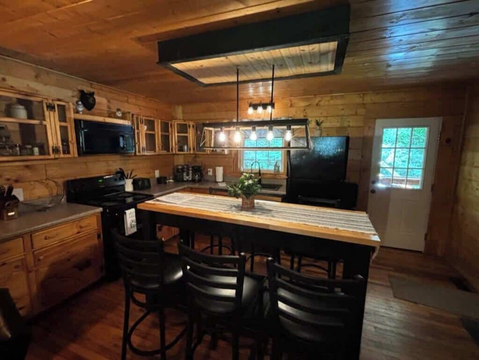 Modern high dining table located just steps from the kitchen.