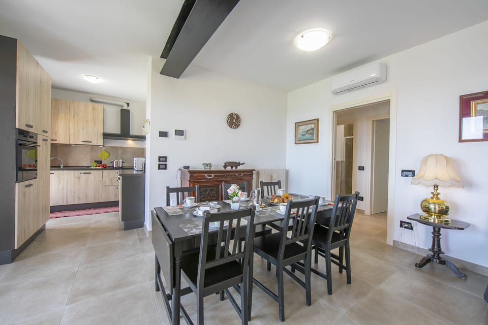 Living room with dining table and equipped kitchen