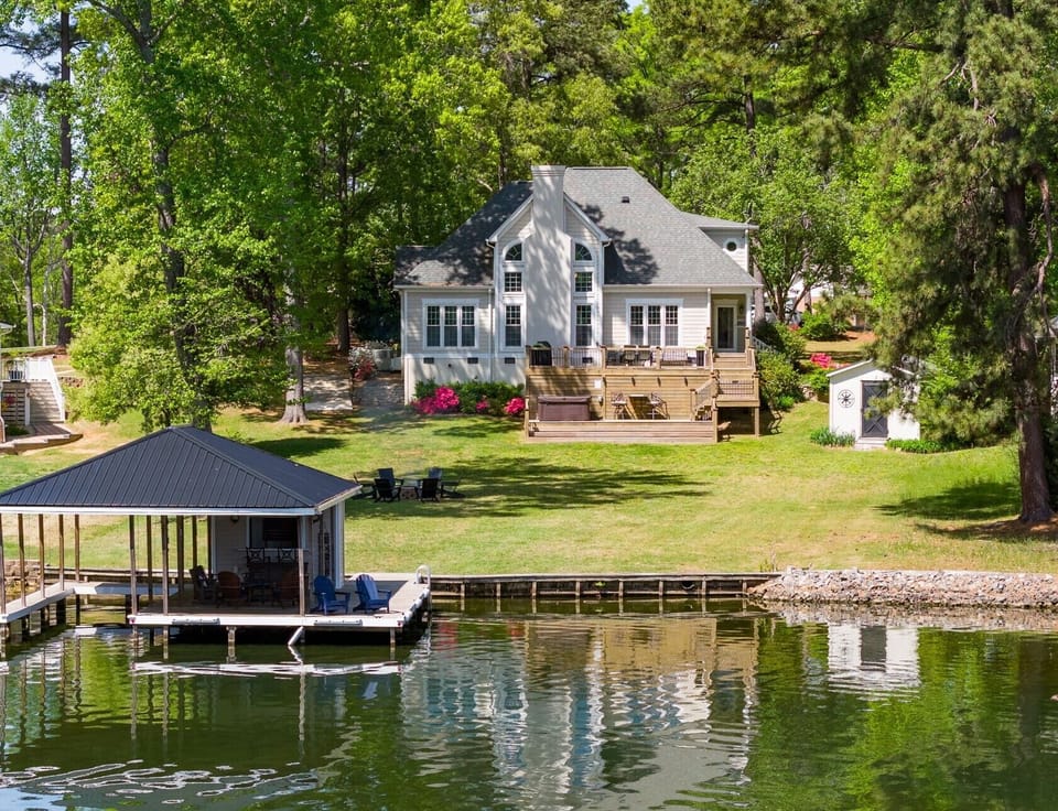 Stunning Private Lakefront Setting with Boathouse and Multi-Level Entertaining Decks