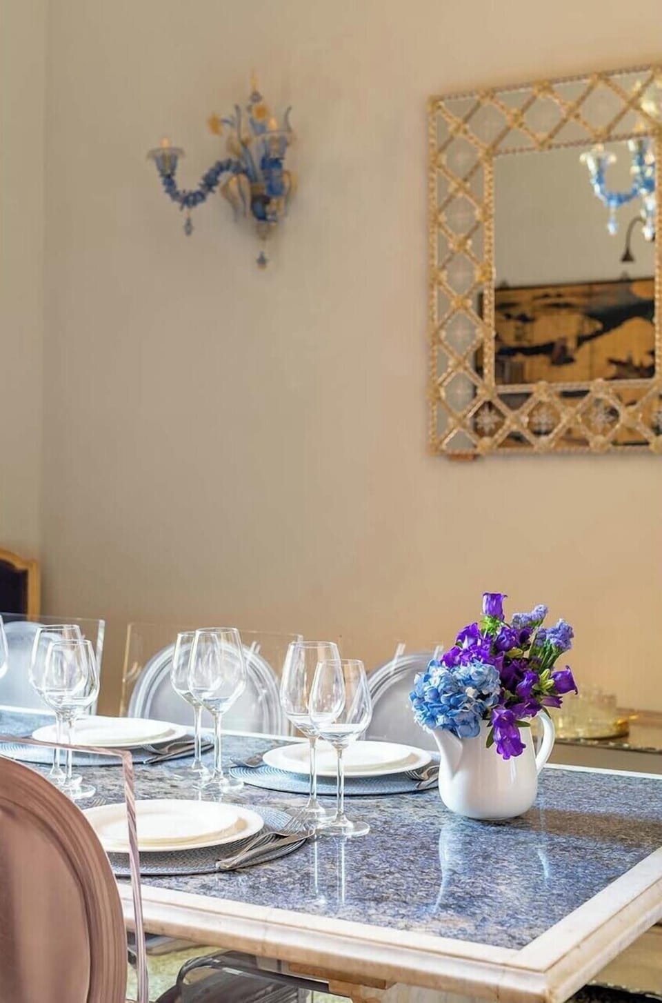 The table is made of striking deep blue marble and comfortably seats 8.