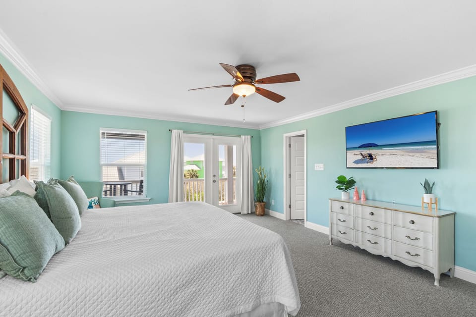 The oversized master bedroom features a king bed, 55 inch television, and access to a private second-story front deck,