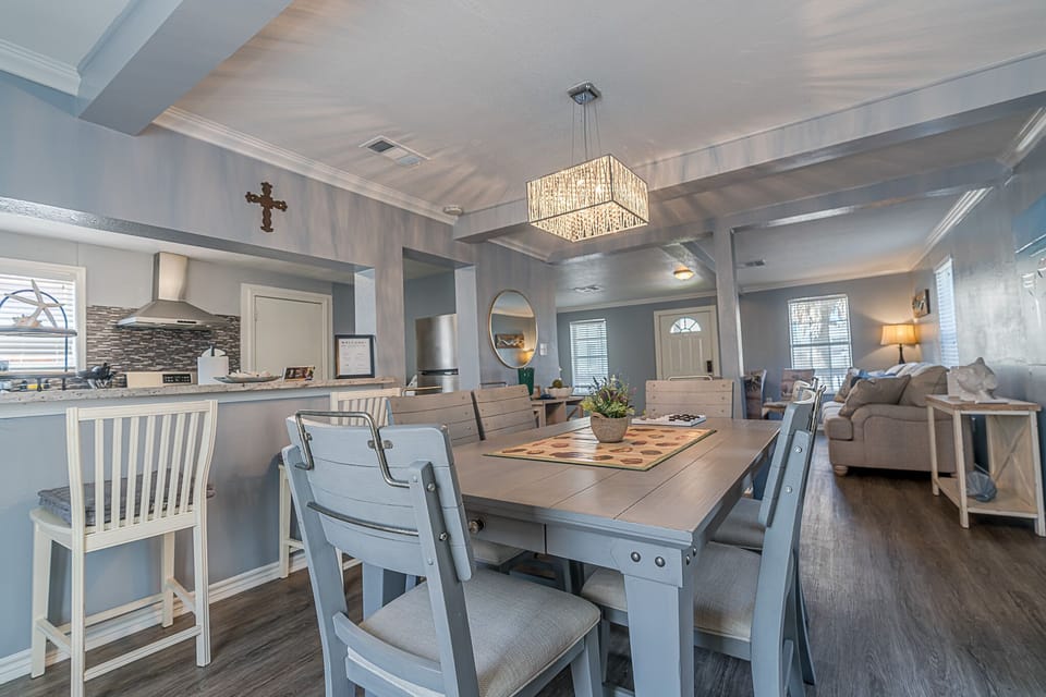 Dining table for 6 with 2 bar area chairs. Great space for games and eating.