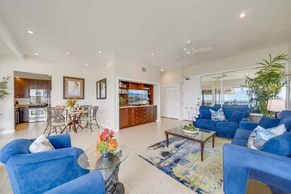 Spacious living room with plush seating, coastal accents, and an open layout that seamlessly connects to the dining and kitchen areas.