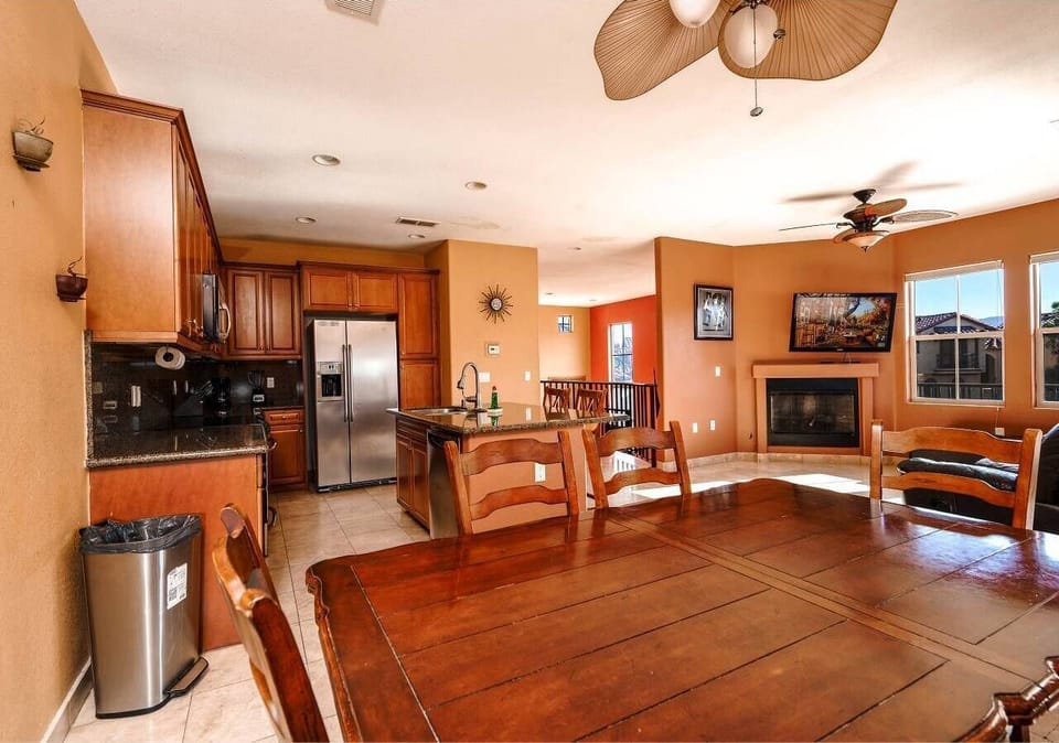 The dining table sits directly off the kitchen, making meals easy to serve without leaving the conversation — part of the open layout in this El Dorado Ranch rental .
