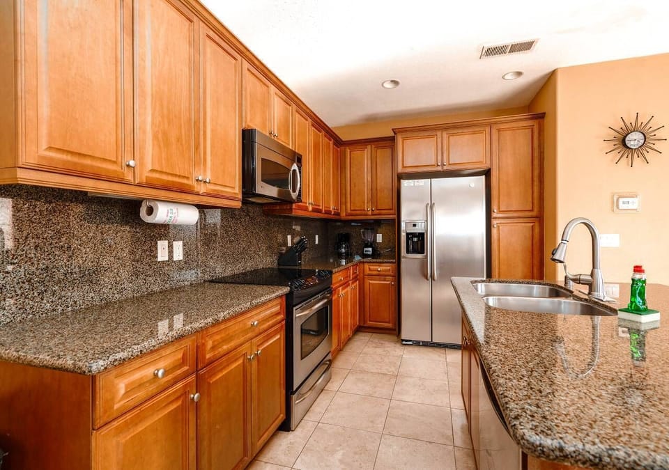 This fully equipped kitchen includes a refrigerator, stove, microwave, and coffee maker — everything you need for home-cooked meals in this El Dorado Ranch vacation rental.