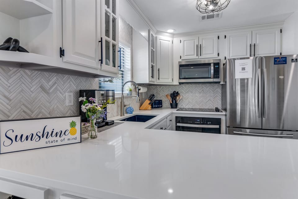 Completely renovated Kitchen w/ gorgeous tile backsplash, new pull-down faucet and granite undermount sink!  Enjoy cooking in the brand new 30" oven and electric glass cooktop!