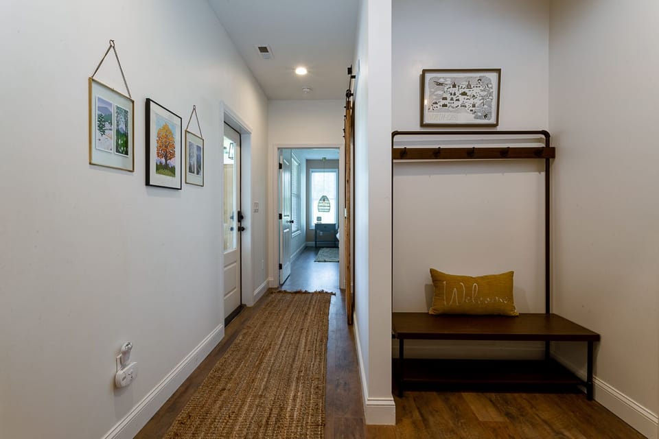 Back inside mudroom hallway leads to Primary BR