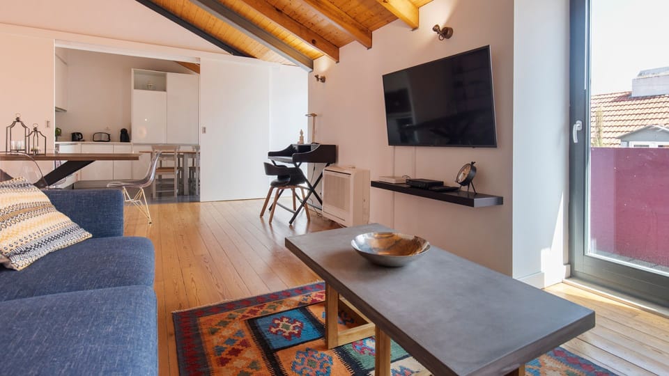 Enjoy lively conversations on the comfortable sofa, catch your favorite shows on the wall-mounted TV, or get some work done at the dedicated workspace, all under charming exposed beam ceilings. The open-plan layout seamlessly connects living and dining ar