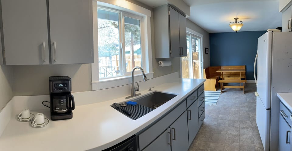 Deep sink, coffee maker and a fully stoked kitchen