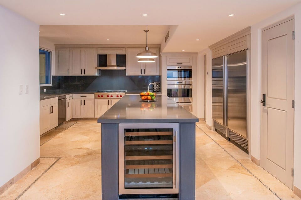 View of the kitchen island with a wine rack built in.