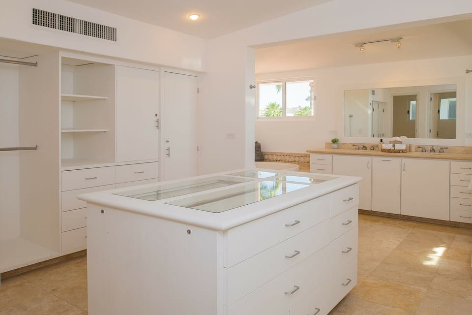A large master closet with a double vanity.