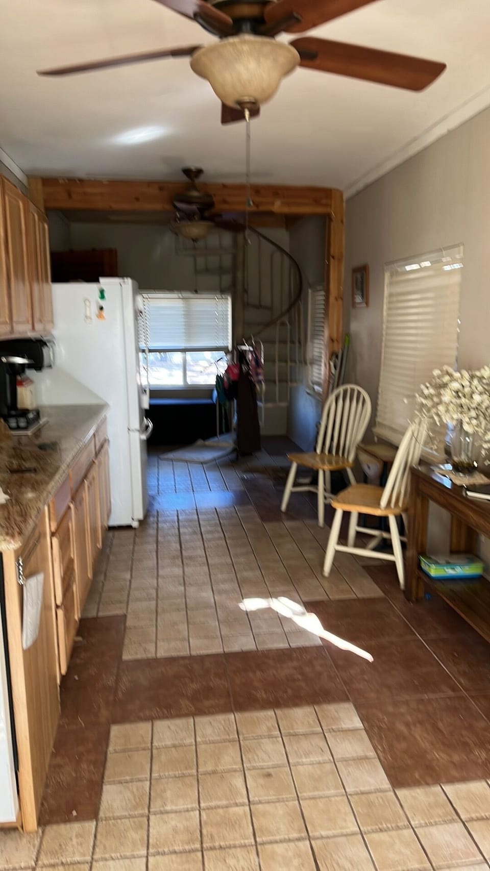 L shape of roomy kitchen, spiral stairway to game room & family bedroom, 2nd Fl 