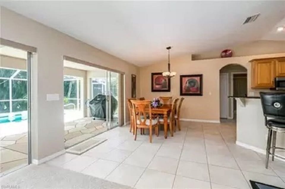 Dining area beside kitchen and outdoor patio. 