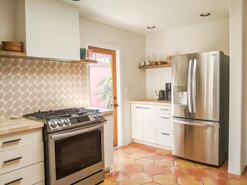 Fully stocked kitchen with new appliances and everything you might need to cook.