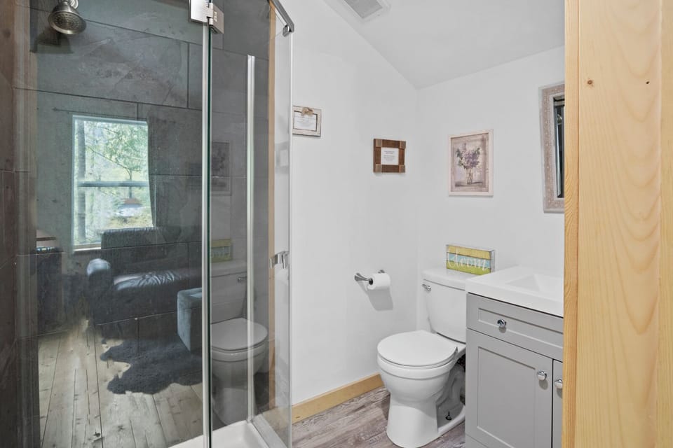 Freshen up in the second-level bathroom with a sleek shower and all essentials.