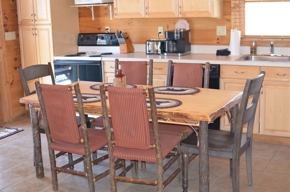 Dining table with 6 chairs along with kitchen counter space to prepare coffee and meals