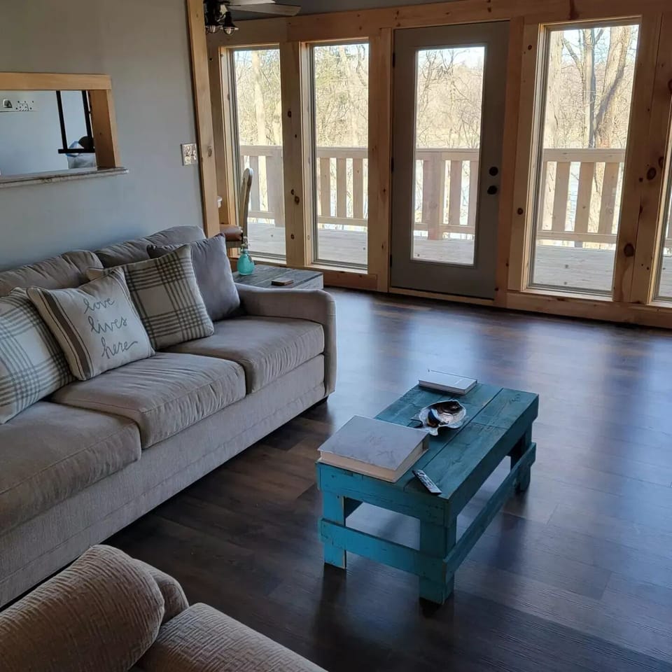 view from recliner.  back wall lined with windows overlooking lake