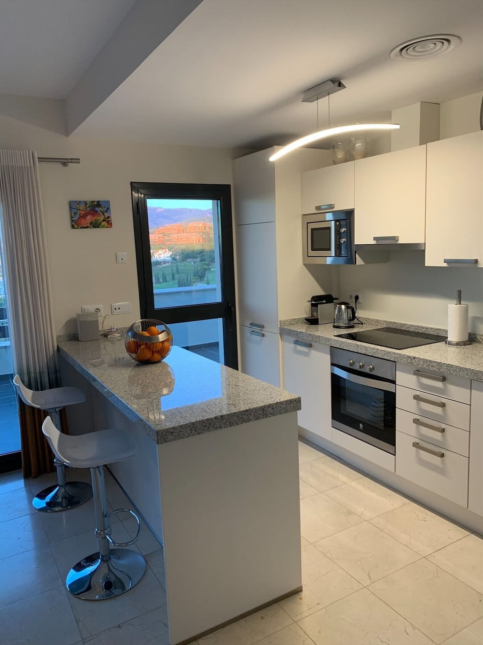 Well stocked kitchen with marble worktops, door to main west-facing terrace