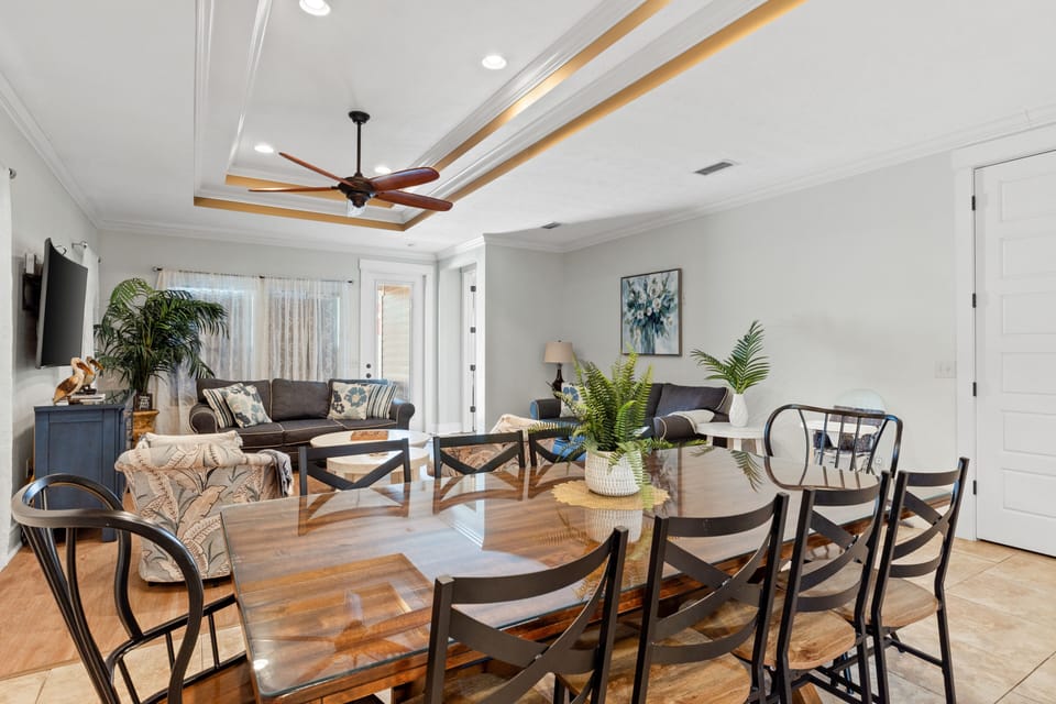 Large dining table with enough seating for 8 people. The dining area is located between the open kitchen and living room areas.
