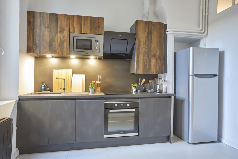 The kitchen has an oven and a micro wave.