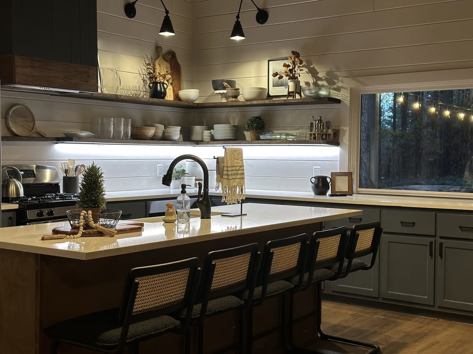 Easy-to-navigate open shelves, a flip out window to the back porch, and plenty of island seating. Our kitchen has every gadget you need to feed your crew!