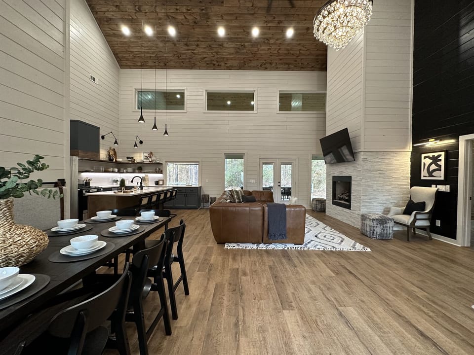 Welcome to Absolutely Still! The sofa is big enough for your whole crew and the table seats 10 - more if you can squeeze some kids on the bench!