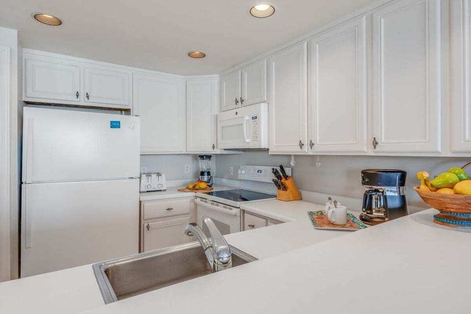 Cook with ease in this clean, stylish kitchen featuring white cabinetry