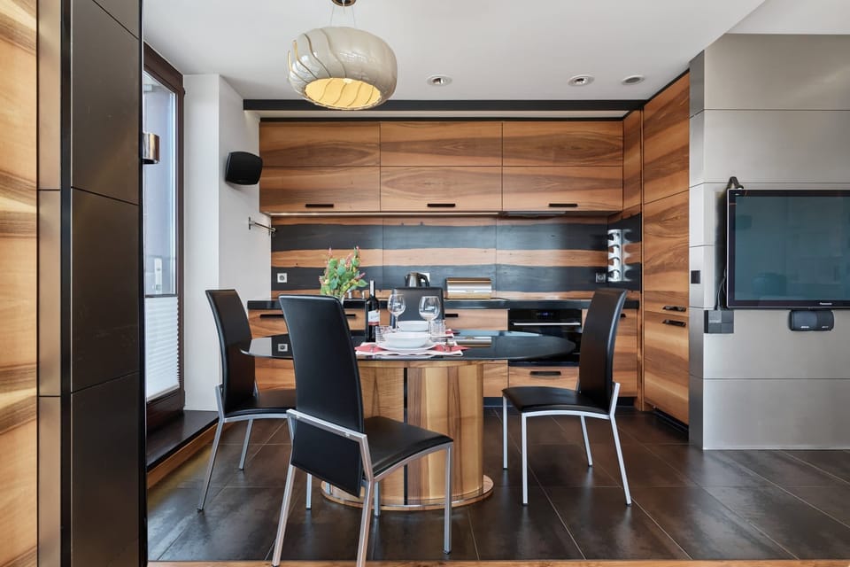 Dining area setup with a table prepared for meals.
