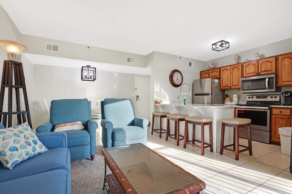 Kitchen - The kitchen is open to both living and dining areas. A large eat-in bar is featured, which provides additional seating when enjoying meals together.