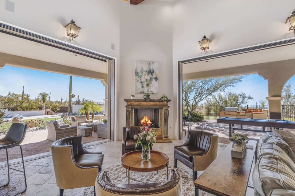 Spacious living room showcases designer furnishings, elegant décor, and floor-to-ceiling windows.