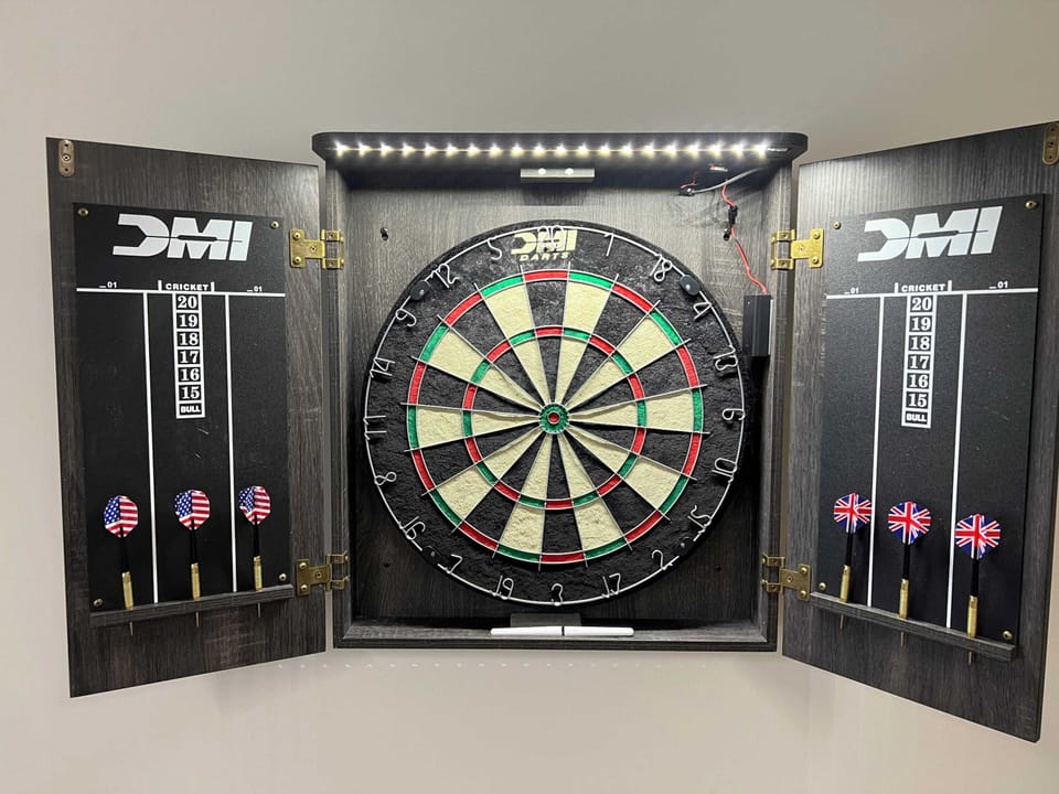 Dart board
on the wall —
friendly
competition mode
activated. The
game room keeps
earning its keep
long after the
novelty of the
simulator wears off.
