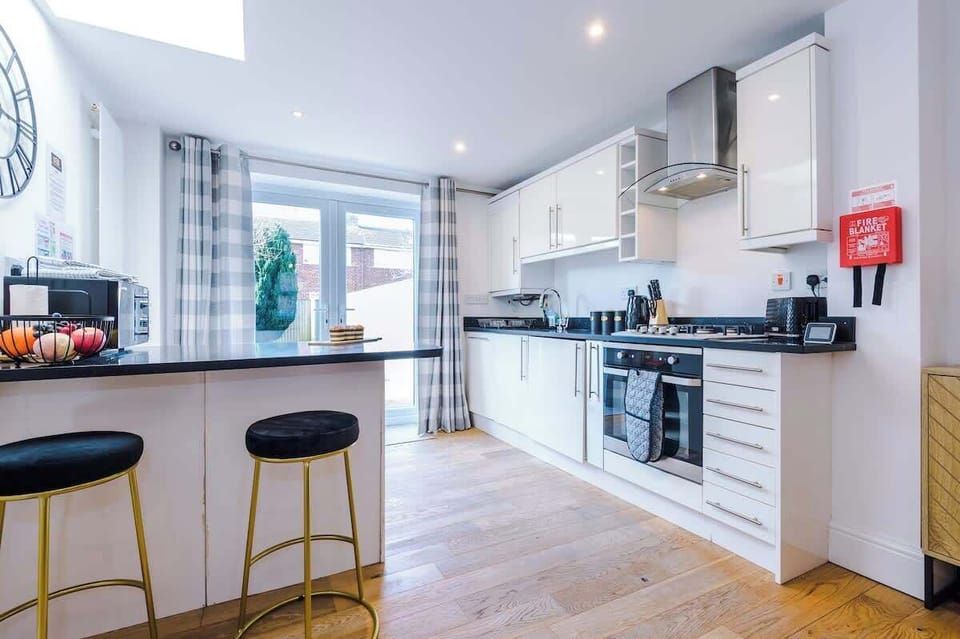 Open plan kitchen/dining area with breakfast bar and all the necessities to cook an array of meals in the evenings after a long day exploring or working in Chester.