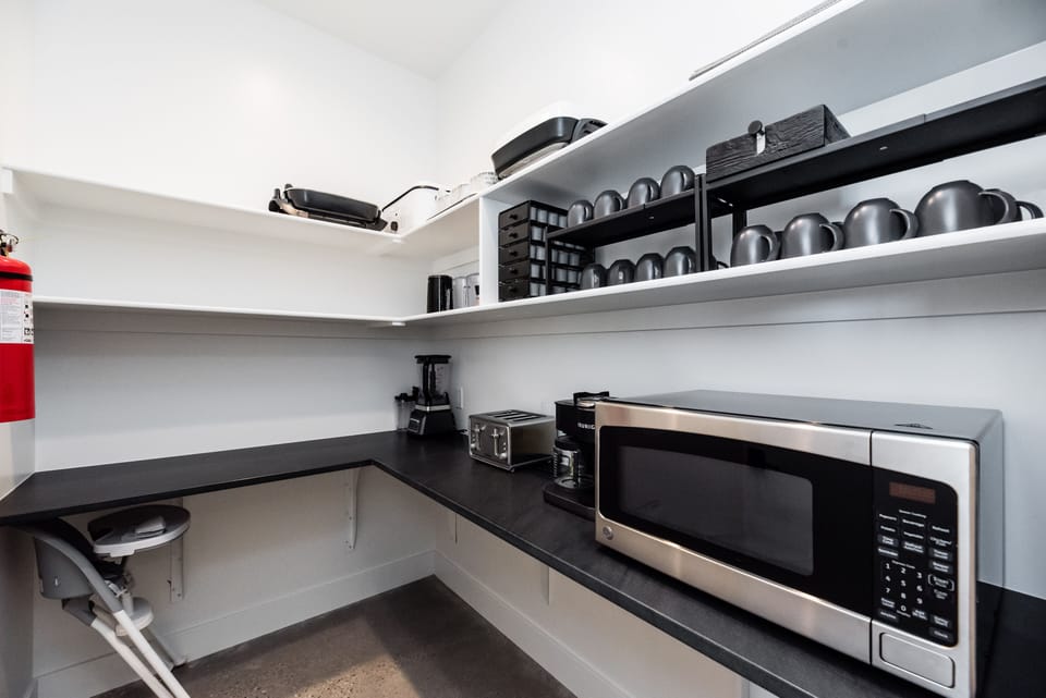 Pantry with small appliances and plenty of shelf space for groceries.