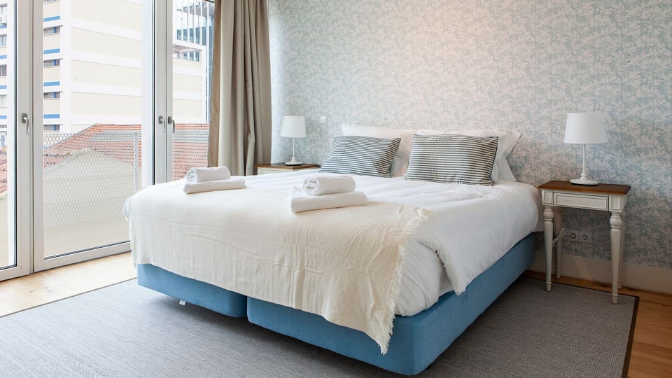 Wake up in a serene and stylish bedroom with soft tones, premium comfort, and plenty of natural light for a restful stay. #CozyBedroom #LisbonApartment #ComfortStay #TravelPortugal #Portugal #PT #Lisbon