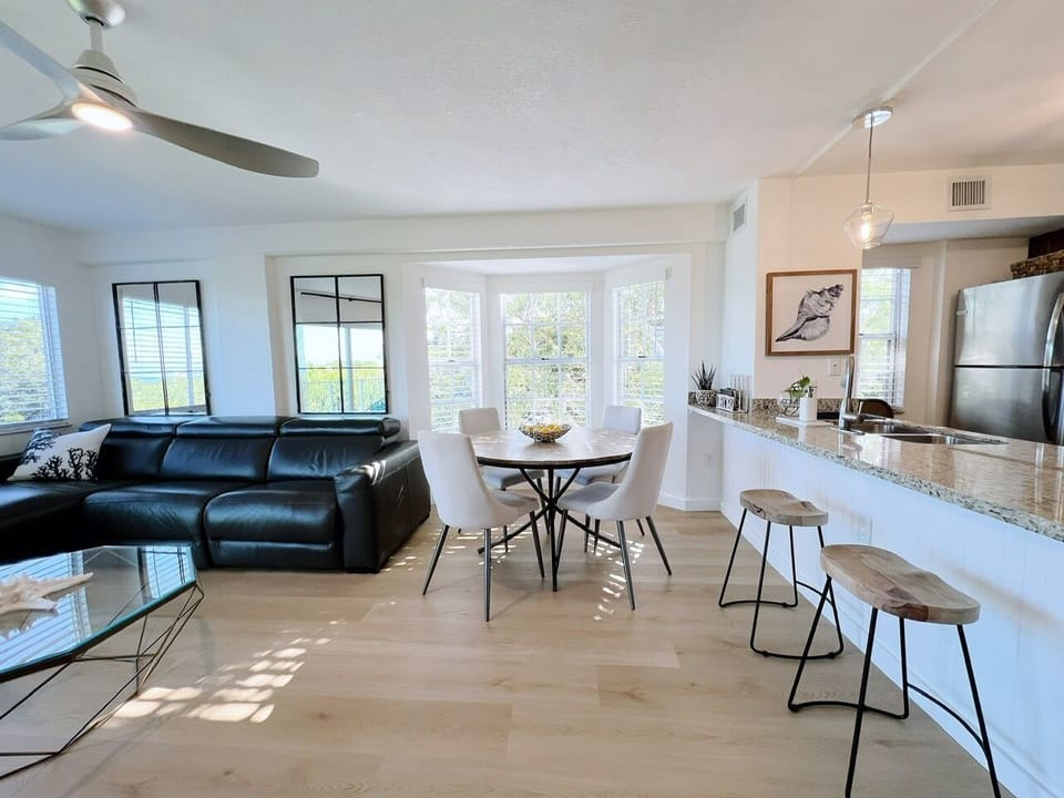 Open space concept living areas - kitchen, 4-person dining area and sofa