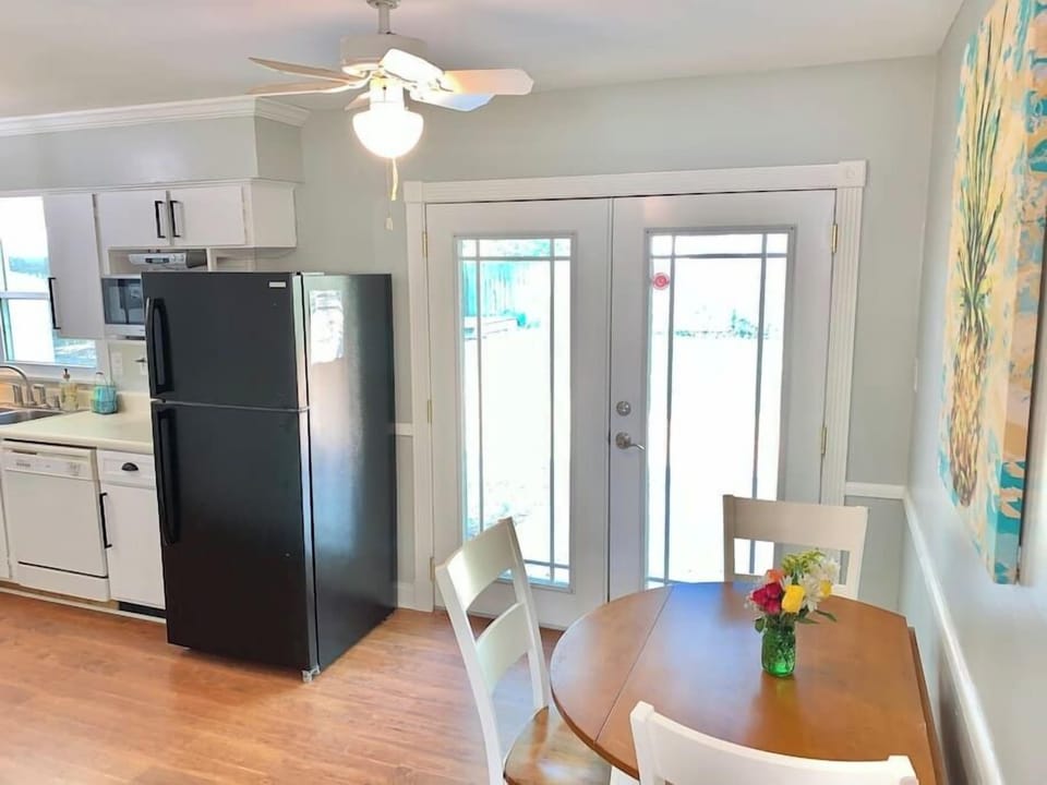Breakfast table in kitchen area and french doors to the back yard.