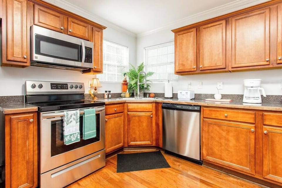 Stainless steel appliances and cherry cabinets.