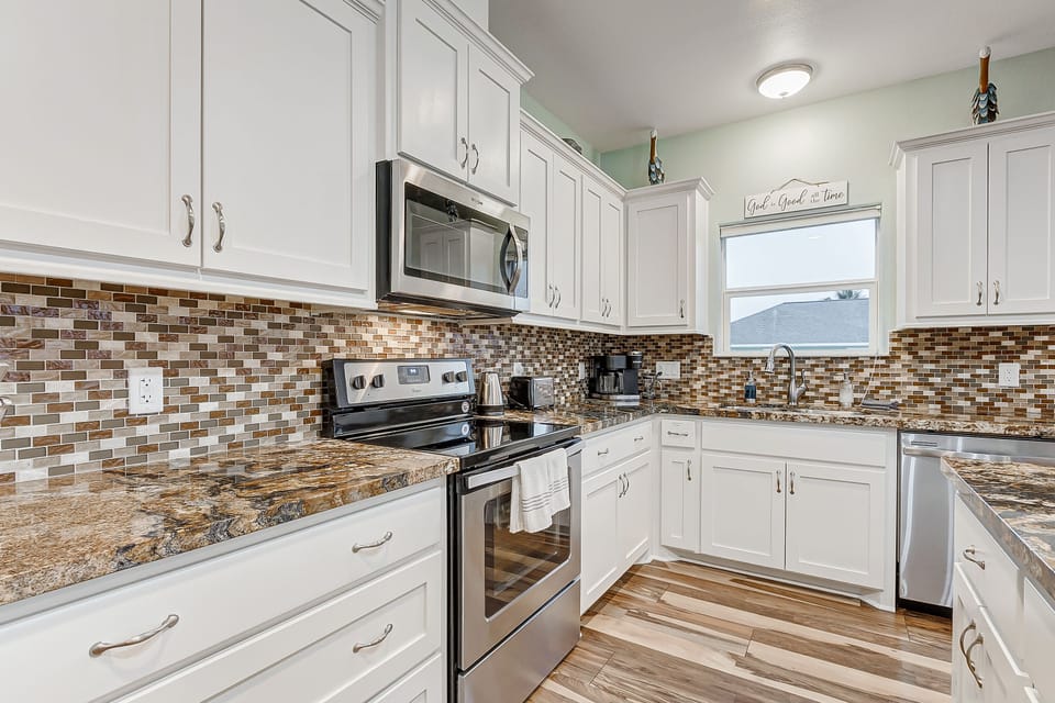 Fully stocked kitchen includes granite countertops. 