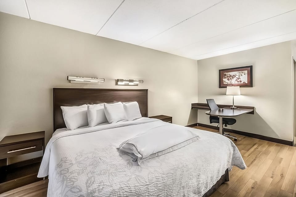 Recharge with plush bedding and a quiet work corner.