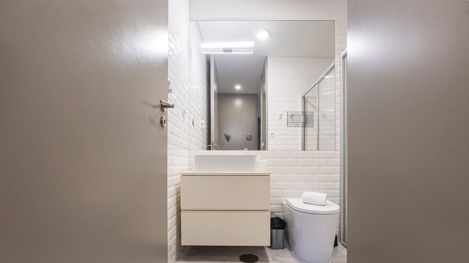 Refresh in a bright, modern bathroom featuring a stylish floating vanity and ample mirror space, perfect for getting ready.
#Bathroom #ModernDesign #LovelyStay